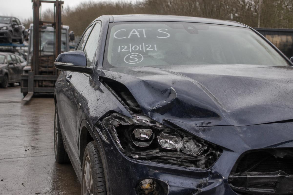 Category S marked damaged car in a UK salvage yard